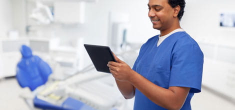 Dentist using tablet in practice